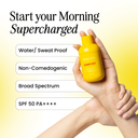 Hand holding a sunny drip sunscreen bottle with product features