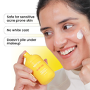 Woman applying cream to her face with a sunnydrip sunscreen
